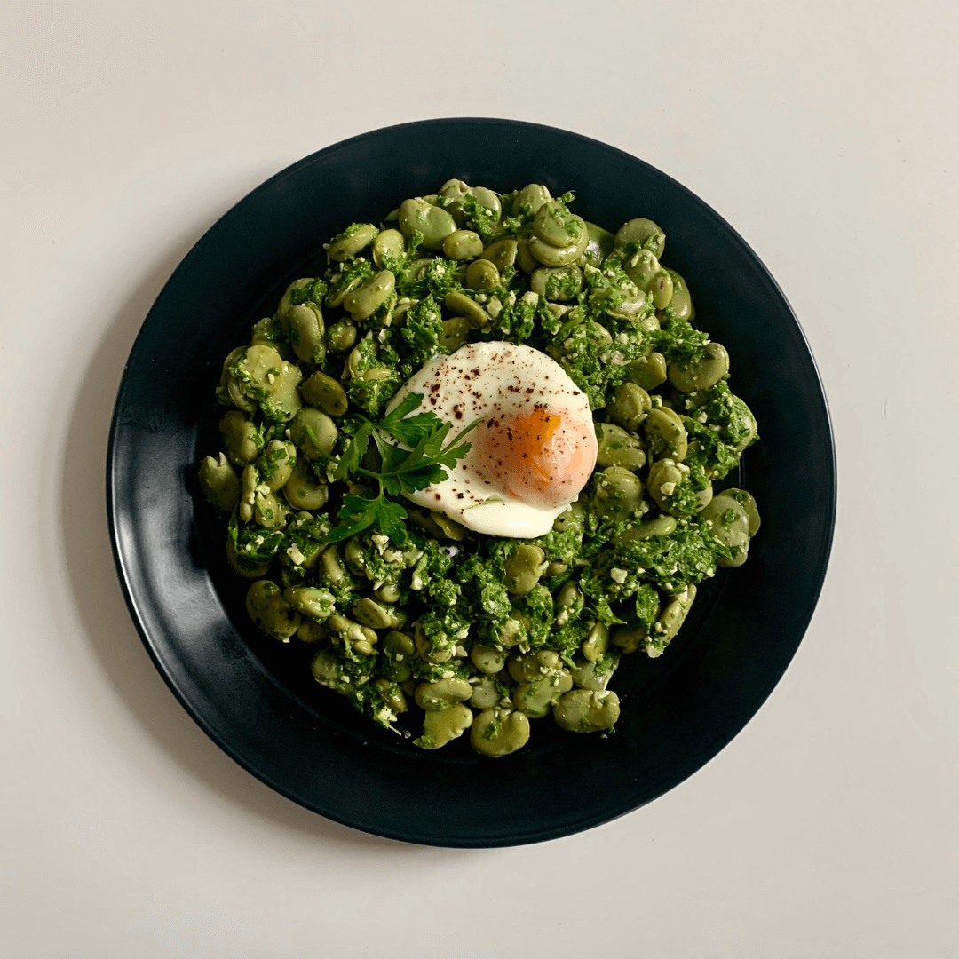 Broad beans with pesto and a poached egg